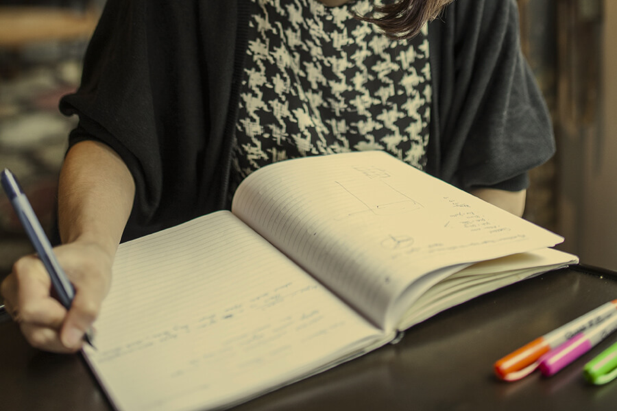 person writing in a notebook